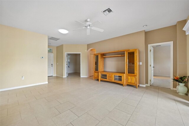 2747 Suncoast Lakes Blvd, Punta Gorda, FL 33980 - living room with a ceiling fan, baseboards, light tile patterned flooring, and arched walkways