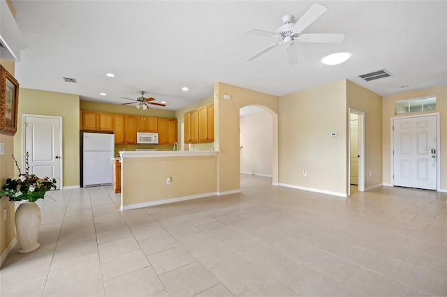 2747 Suncoast Lakes Blvd, Punta Gorda, FL 33980 - unfurnished living room featuring a ceiling fan, arched walkways, light tile patterned flooring, baseboards, and recessed lighting