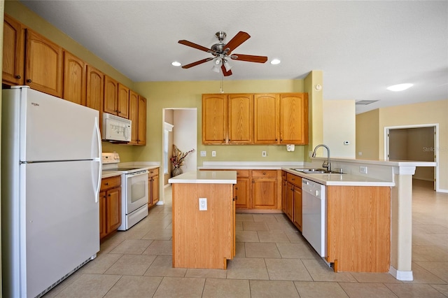 2747 Suncoast Lakes Blvd, Punta Gorda, FL 33980 - kitchen featuring white appliances, a sink, a peninsula, ceiling fan, and a center island