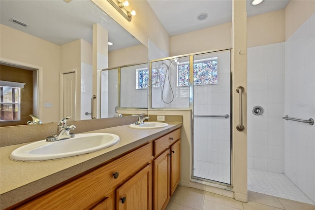 2747 Suncoast Lakes Blvd, Punta Gorda, FL 33980 - bathroom with a tile shower, double vanity, and tile patterned floors