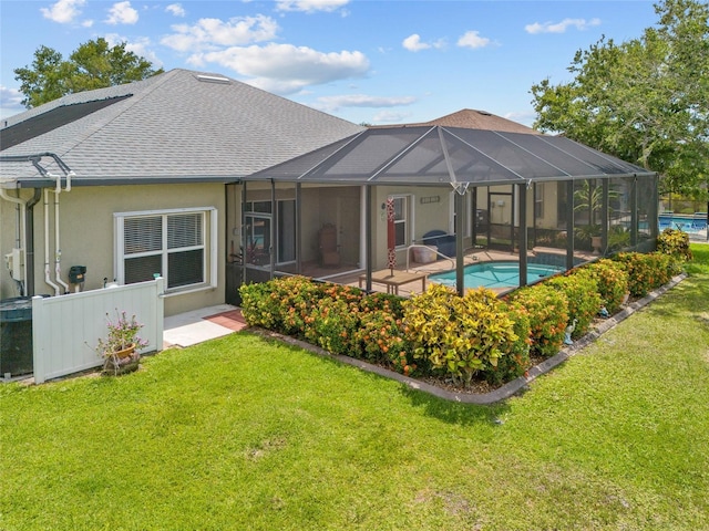 2747 Suncoast Lakes Blvd, Punta Gorda, FL 33980 - back of property featuring a shingled roof, an outdoor pool, and a lawn