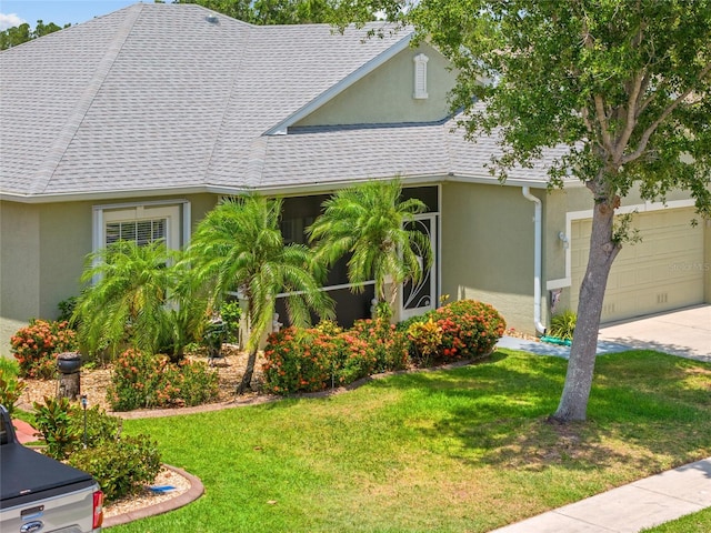 2747 Suncoast Lakes Blvd, Punta Gorda, FL 33980 - view of front of property with stucco siding, a garage, a front lawn, and a shingled roof