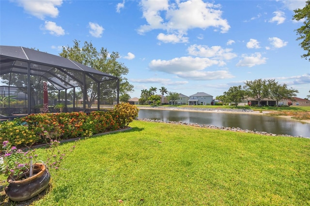 2747 Suncoast Lakes Blvd, Punta Gorda, FL 33980 - view of grassy yard featuring a water view, a residential view, and glass enclosure