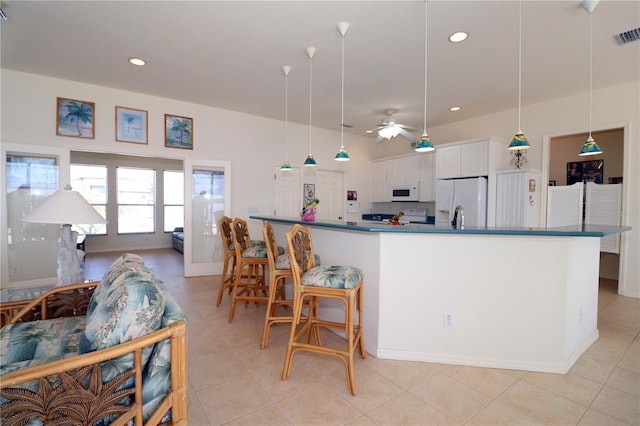 3772 Peace River Dr, Punta Gorda, FL 33983 - kitchen with white appliances, dark countertops, ceiling fan, white cabinetry, and recessed lighting