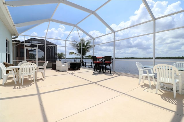 3772 Peace River Dr, Punta Gorda, FL 33983 - view of patio featuring outdoor dining space, a water view, and glass enclosure