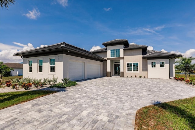 5061 Collingswood Blvd, Port Charlotte, FL 33948 - prairie-style home featuring decorative driveway, a garage, and stucco siding