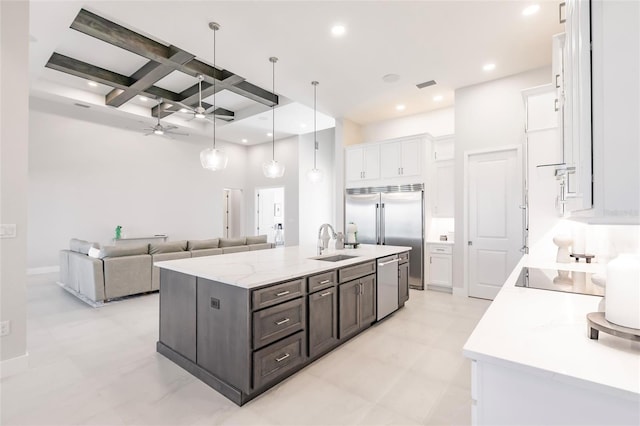 5061 Collingswood Blvd, Port Charlotte, FL 33948 - kitchen featuring a sink, stainless steel appliances, white cabinetry, coffered ceiling, and beam ceiling