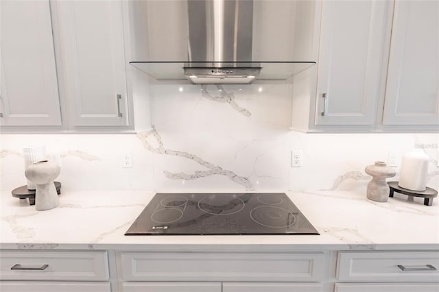 5061 Collingswood Blvd, Port Charlotte, FL 33948 - kitchen featuring range hood, black electric cooktop, backsplash, and white cabinetry