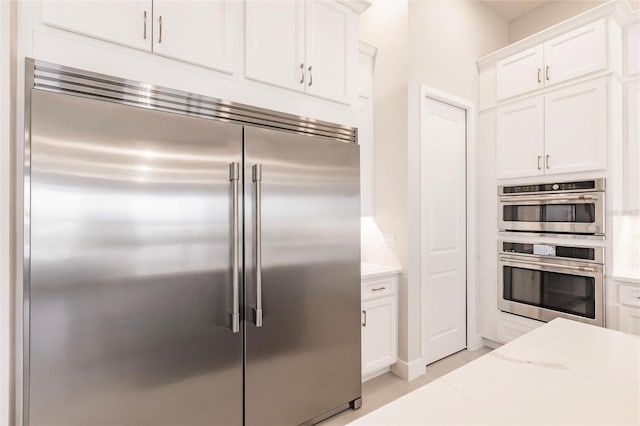 5061 Collingswood Blvd, Port Charlotte, FL 33948 - kitchen with appliances with stainless steel finishes, white cabinets, and light stone counters