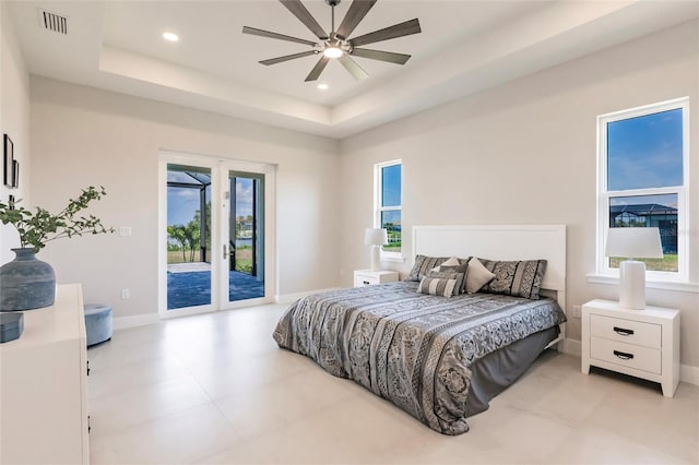 5061 Collingswood Blvd, Port Charlotte, FL 33948 - bedroom featuring access to exterior, multiple windows, a tray ceiling, baseboards, and recessed lighting
