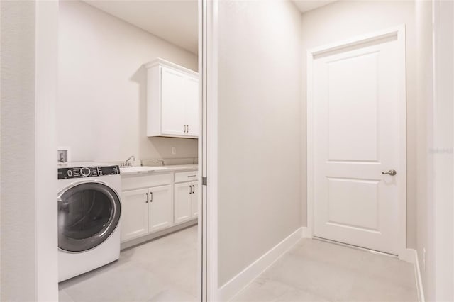 5061 Collingswood Blvd, Port Charlotte, FL 33948 - laundry room with washer / dryer, cabinet space, and baseboards