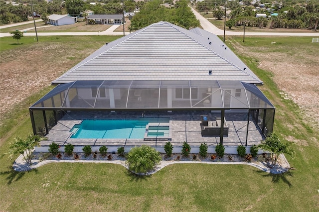 5061 Collingswood Blvd, Port Charlotte, FL 33948 - view of swimming pool featuring glass enclosure, a patio area, a yard, and a pool with connected hot tub