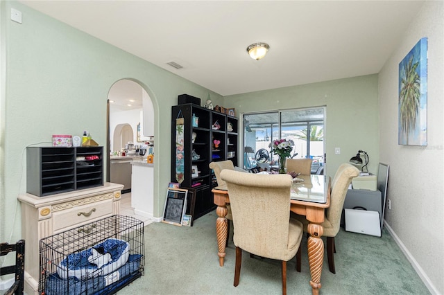 6103 Fabian Rd, North Port, FL 34287 - dining room with arched walkways, light carpet, and baseboards