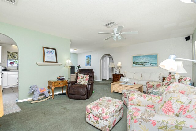 6103 Fabian Rd, North Port, FL 34287 - carpeted living area featuring arched walkways, a ceiling fan, and baseboards