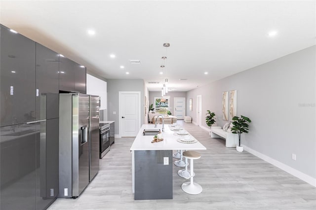 14350 Marlin Ave, Port Charlotte, FL 33953 - kitchen featuring stainless steel appliances, a sink, modern cabinets, a kitchen bar, and light countertops