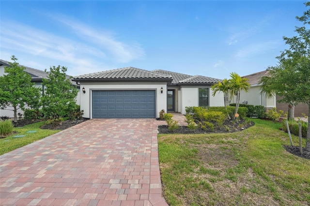16053 Rosemallow Ln, Alva, FL 33920 - view of front of house with stucco siding, an attached garage, and decorative driveway