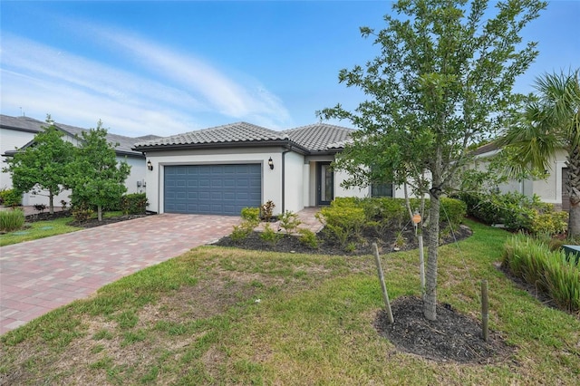 16053 Rosemallow Ln, Alva, FL 33920 - view of front facade featuring a garage, a tile roof, driveway, stucco siding, and a front lawn