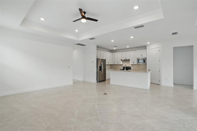 16053 Rosemallow Ln, Alva, FL 33920 - unfurnished living room featuring a raised ceiling, a sink, a ceiling fan, recessed lighting, and baseboards