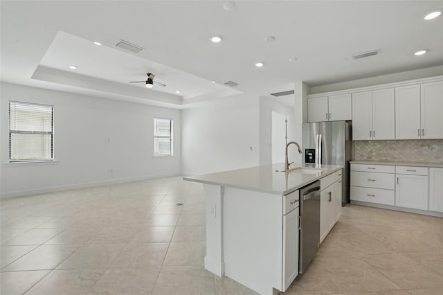 16053 Rosemallow Ln, Alva, FL 33920 - kitchen featuring appliances with stainless steel finishes, a sink, open floor plan, backsplash, and light countertops