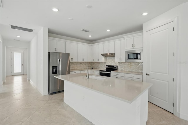 16053 Rosemallow Ln, Alva, FL 33920 - kitchen with appliances with stainless steel finishes, under cabinet range hood, a sink, decorative backsplash, and light countertops