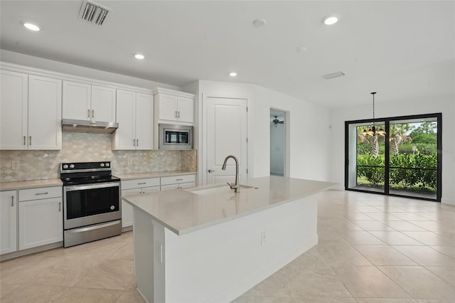 16053 Rosemallow Ln, Alva, FL 33920 - kitchen featuring appliances with stainless steel finishes, under cabinet range hood, a sink, light countertops, and backsplash