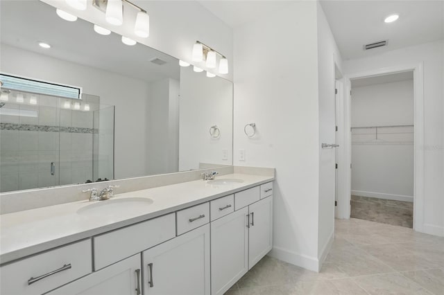 16053 Rosemallow Ln, Alva, FL 33920 - bathroom with double vanity, a shower stall, a spacious closet, baseboards, and recessed lighting