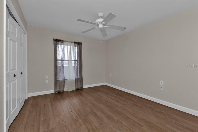 601 Shreve St Unit 64C, Punta Gorda, FL 33950 - unfurnished bedroom with a closet, dark wood-style flooring, baseboards, and a ceiling fan