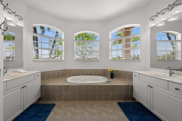3219 SW 7th Ln, Cape Coral, FL 33991 - bathroom featuring two vanities, a garden tub, and tile patterned flooring