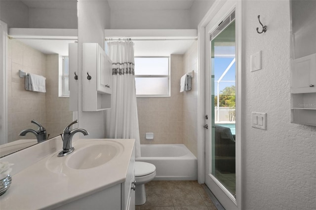 3219 SW 7th Ln, Cape Coral, FL 33991 - bathroom with toilet, vanity, tile patterned floors, a textured wall, and shower / bath combo
