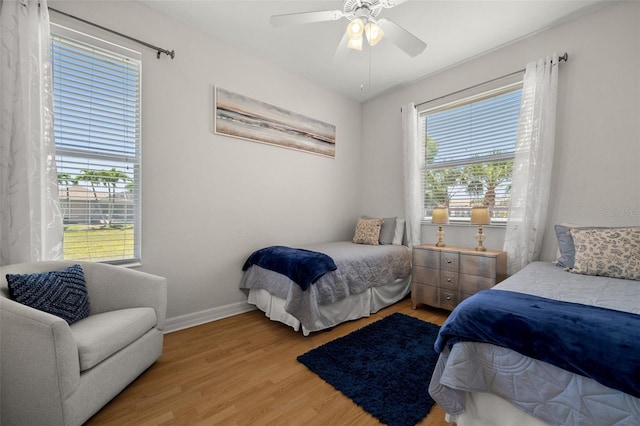 3219 SW 7th Ln, Cape Coral, FL 33991 - bedroom with light wood-type flooring, baseboards, and a ceiling fan