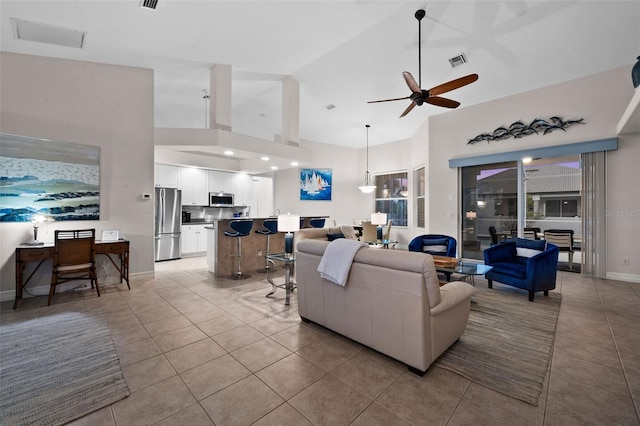 3219 SW 7th Ln, Cape Coral, FL 33991 - living area with high vaulted ceiling, light tile patterned floors, a ceiling fan, and baseboards