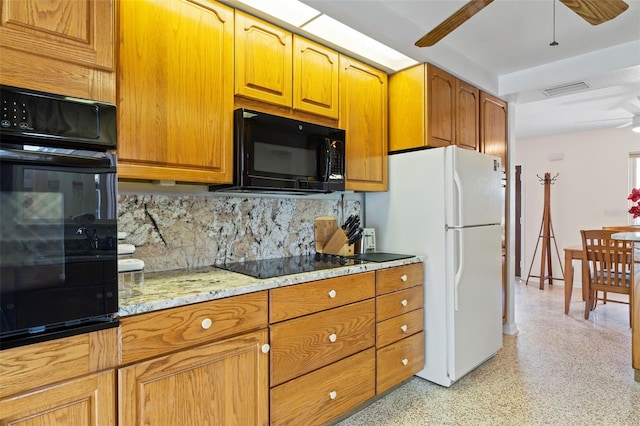125 Small St SE, Port Charlotte, FL 33952 - kitchen with black appliances, a ceiling fan, decorative backsplash, light stone countertops, and brown cabinets