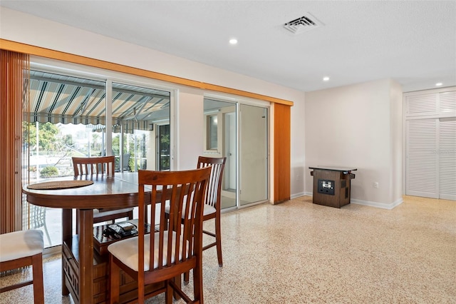 125 Small St SE, Port Charlotte, FL 33952 - dining room featuring dark aggregate flooring, recessed lighting, and baseboards