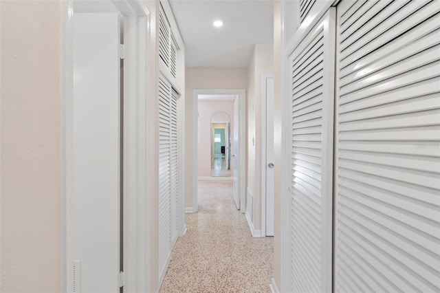 125 Small St SE, Port Charlotte, FL 33952 - corridor featuring dark aggregate flooring, baseboards, and recessed lighting