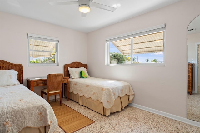 125 Small St SE, Port Charlotte, FL 33952 - bedroom featuring baseboards, dark aggregate flooring, and a ceiling fan