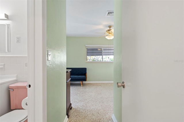125 Small St SE, Port Charlotte, FL 33952 - bathroom featuring speckled floor, ceiling fan, and toilet