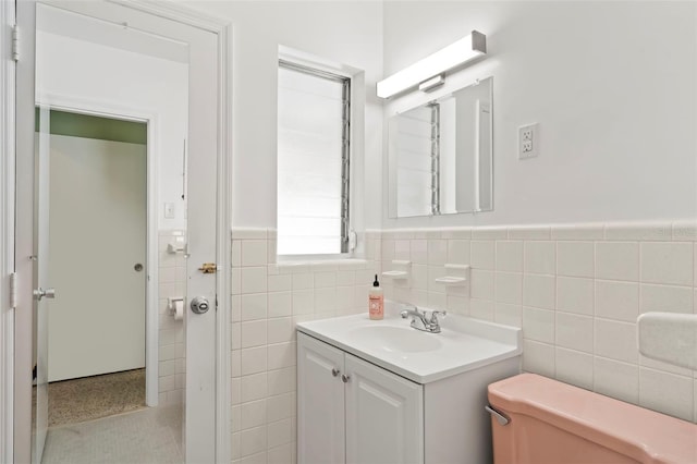 125 Small St SE, Port Charlotte, FL 33952 - bathroom featuring tile walls, vanity, wainscoting, and toilet