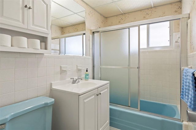 125 Small St SE, Port Charlotte, FL 33952 - bathroom featuring healthy amount of natural light, wallpapered walls, toilet, vanity, and combined bath / shower with glass door