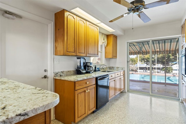 125 Small St SE, Port Charlotte, FL 33952 - kitchen with dishwasher, dark speckled floor, a ceiling fan, a sink, and light stone countertops