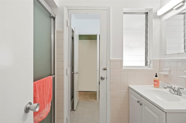 125 Small St SE, Port Charlotte, FL 33952 - full bathroom featuring vanity, tile walls, a wainscoted wall, and tile patterned floors