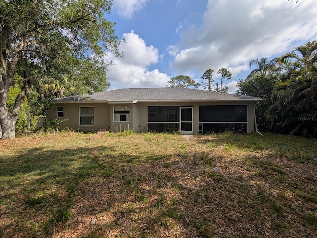 4205 Simkins Ave, North Port, FL 34286 - back of property with a lawn, a sunroom, and stucco siding