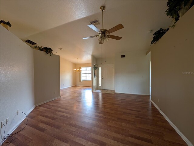 4205 Simkins Ave, North Port, FL 34286 - empty room featuring a chandelier, wood finished floors, a ceiling fan, vaulted ceiling, and baseboards