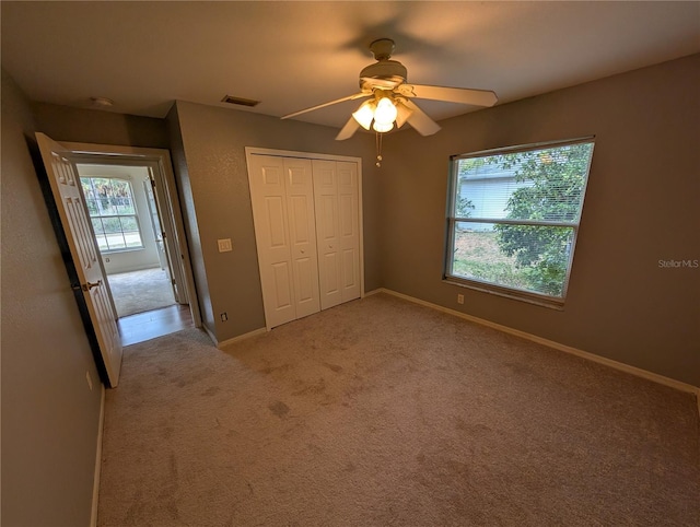 4205 Simkins Ave, North Port, FL 34286 - unfurnished bedroom featuring a closet, baseboards, light carpet, and a ceiling fan