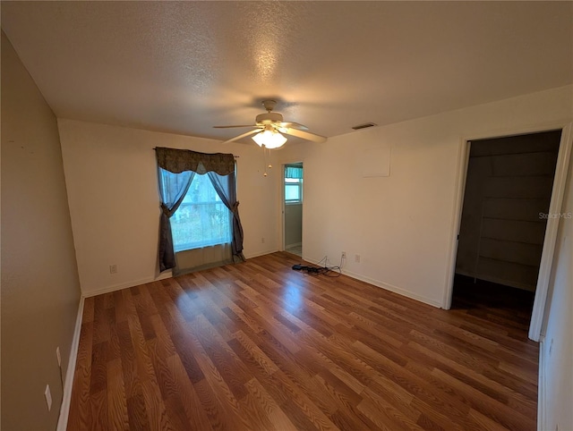 4205 Simkins Ave, North Port, FL 34286 - empty room featuring a ceiling fan, wood finished floors, a textured ceiling, and baseboards