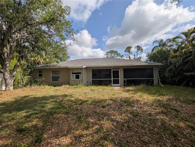 4205 Simkins Ave, North Port, FL 34286 - back of property featuring a yard, a sunroom, and stucco siding