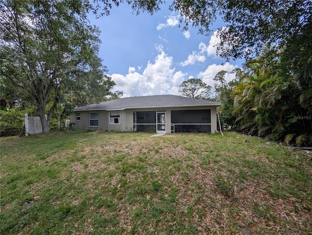 4205 Simkins Ave, North Port, FL 34286 - back of house featuring a sunroom, a yard, and stucco siding