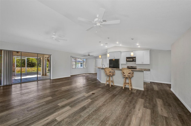 1210 Mccrory St, North Port, FL 34286 - kitchen featuring black appliances, lofted ceiling, open floor plan, ceiling fan, and a center island with sink