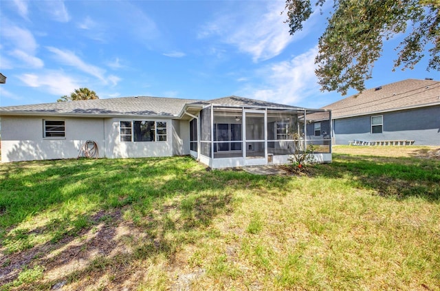 1210 Mccrory St, North Port, FL 34286 - back of house with a lawn, stucco siding, and a sunroom