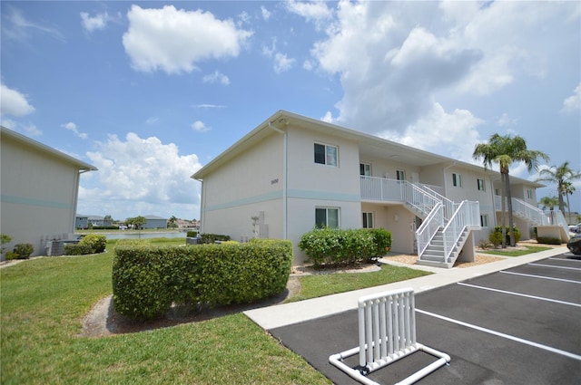 12538 SW Kingsway Cir Unit 1602, Lake Suzy, FL 34269 - view of building exterior with uncovered parking and stairway