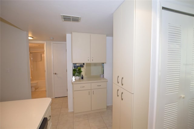 12538 SW Kingsway Cir Unit 1602, Lake Suzy, FL 34269 - kitchen featuring light tile patterned floors, light countertops, and white cabinets